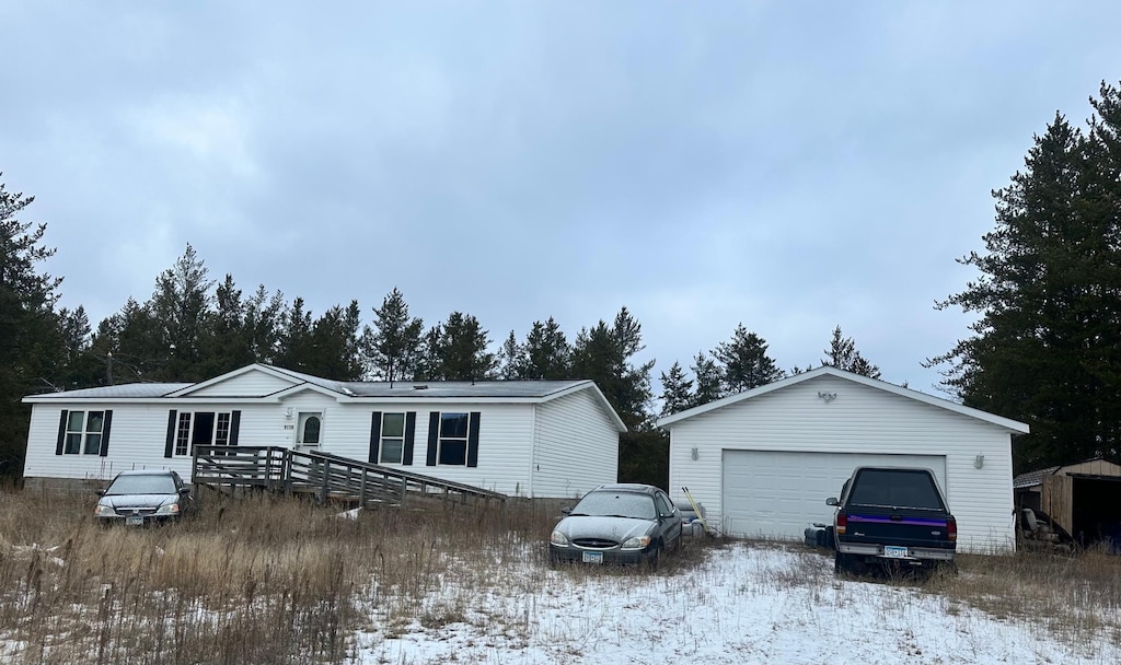 view of front of property featuring a garage and an outbuilding