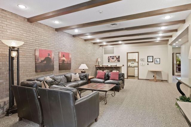 living room with beamed ceiling, brick wall, light colored carpet, and a textured ceiling