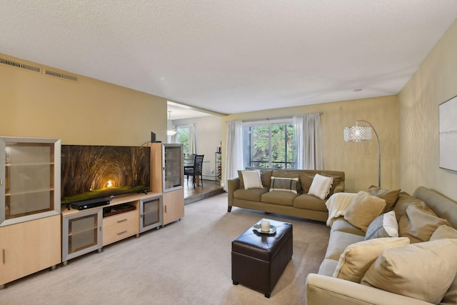 carpeted living room featuring a textured ceiling