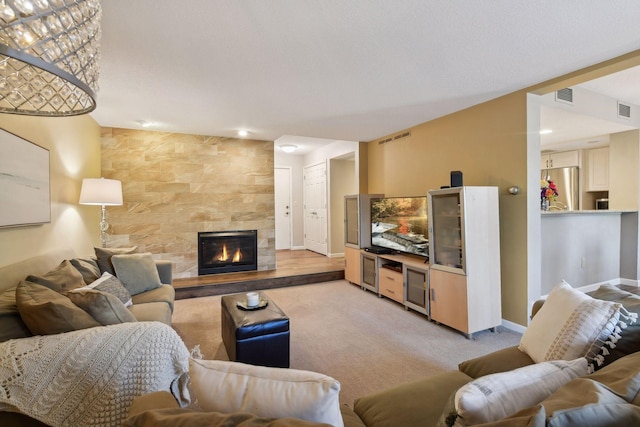 carpeted living room featuring a tile fireplace