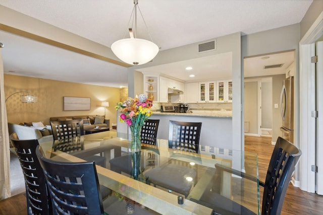 dining space featuring dark wood-type flooring