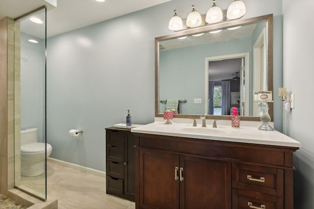 bathroom with vanity, a shower, and toilet