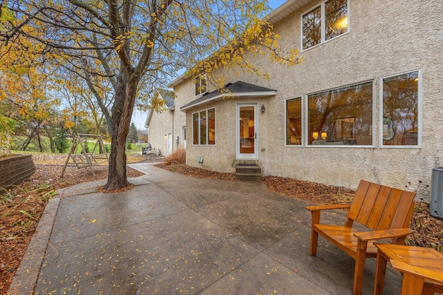 back of property featuring central AC and a patio