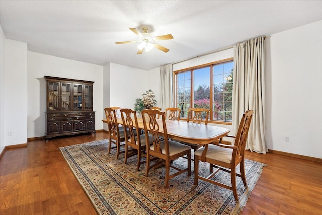 dining room featuring ceiling fan, a textured ceiling, and dark hardwood / wood-style floors