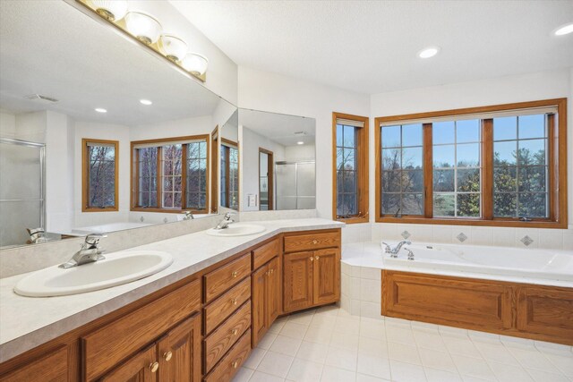 bathroom with vanity, tile patterned floors, and plus walk in shower