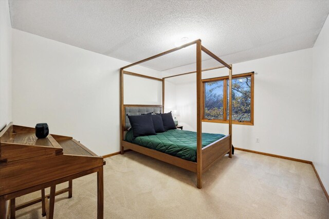 carpeted bedroom featuring a textured ceiling