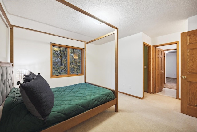 carpeted bedroom featuring a textured ceiling