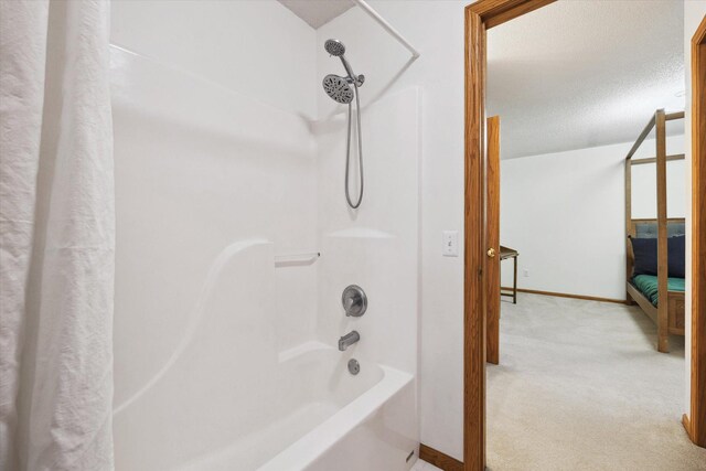 bathroom featuring a textured ceiling and shower / bath combo