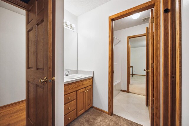 bathroom featuring vanity and a textured ceiling