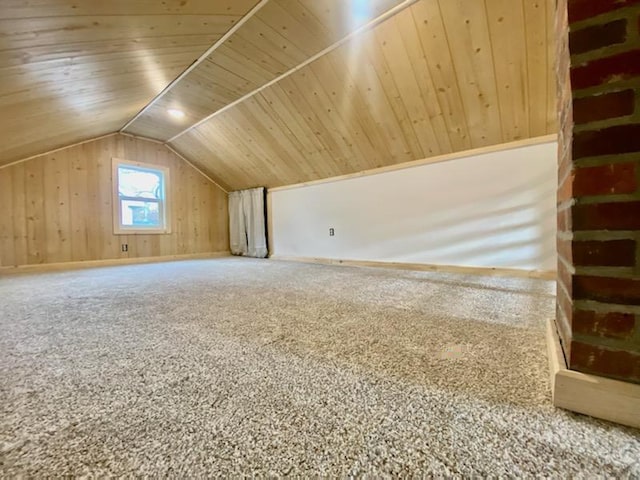 additional living space featuring wooden walls, vaulted ceiling, wooden ceiling, and carpet flooring