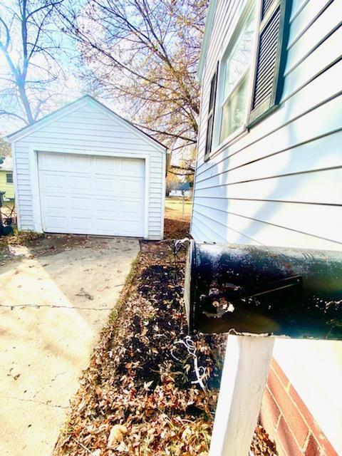 view of home's exterior with a garage and an outdoor structure