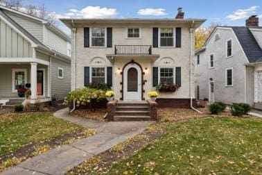 view of front of property with a front yard and a chimney