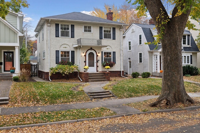 view of front of property featuring stucco siding and a chimney