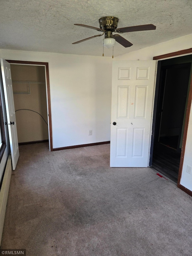 unfurnished bedroom with a closet, carpet, a textured ceiling, and ceiling fan