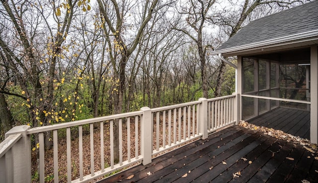 wooden deck with a sunroom