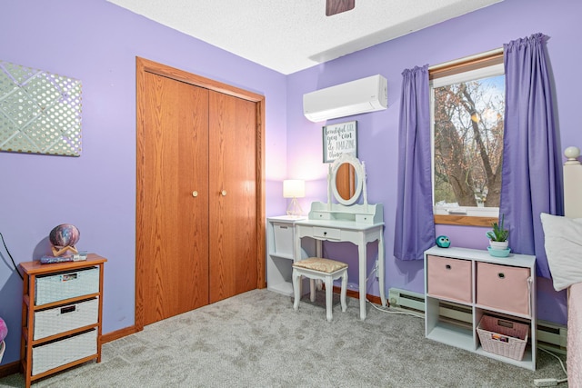 game room with an AC wall unit, light carpet, and a textured ceiling