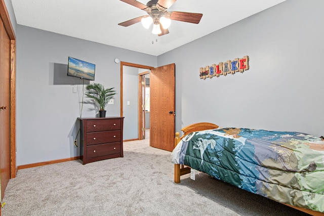 bedroom featuring light colored carpet and ceiling fan