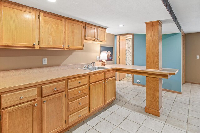 kitchen featuring sink and light tile patterned floors