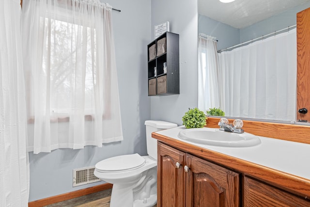 bathroom with visible vents, toilet, and vanity