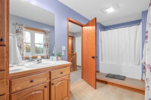 full bath featuring vanity, shower / tub combo, wood finished floors, and visible vents