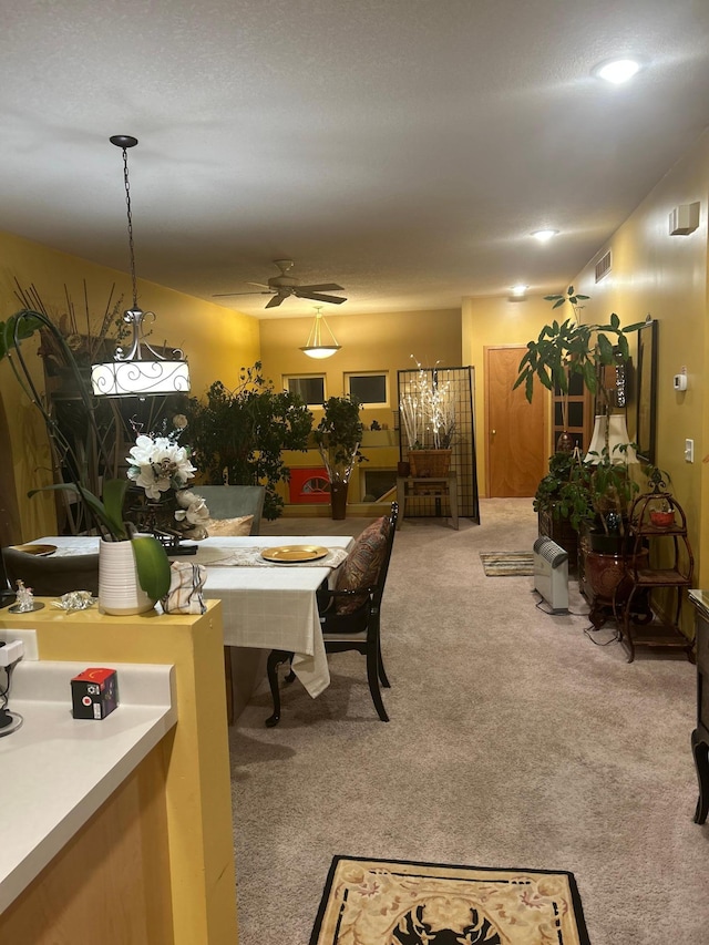 dining area with light carpet and ceiling fan