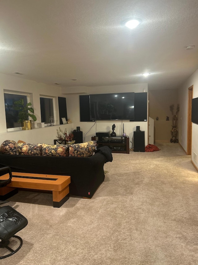 carpeted living room featuring a textured ceiling