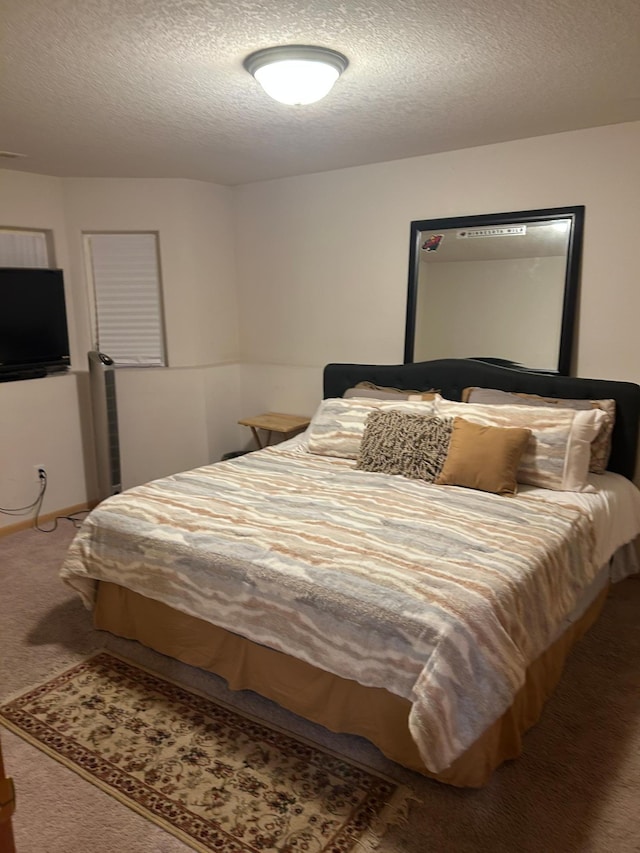 bedroom with a textured ceiling and carpet floors