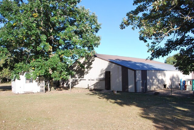 12303 71st Ave SW, Motley, MN 56466 - back of property with an outdoor structure, an outbuilding, metal roof, and a yard