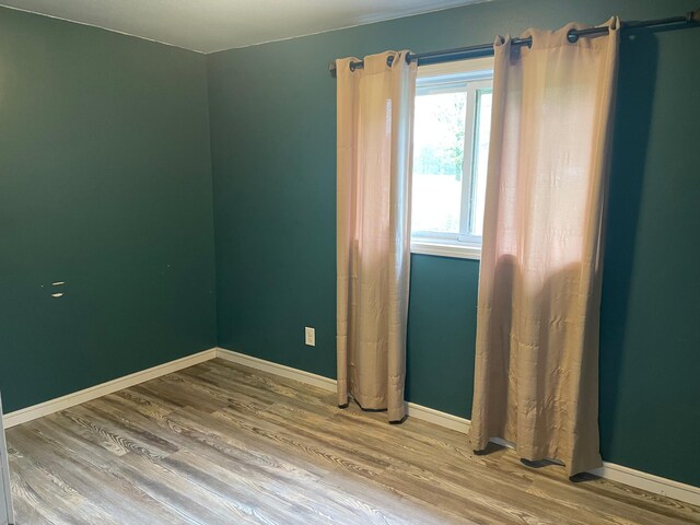 12303 71st Ave SW, Motley, MN 56466 - empty room with wood finished floors and baseboards
