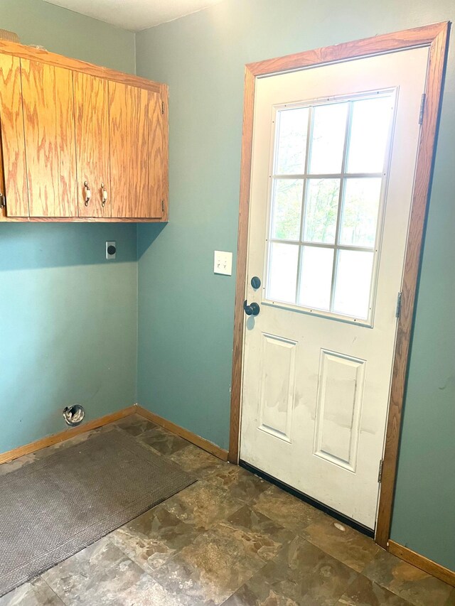 12303 71st Ave SW, Motley, MN 56466 - laundry room featuring cabinet space, baseboards, and stone finish flooring