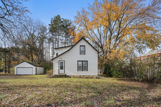 exterior space with a front lawn, a garage, and an outdoor structure