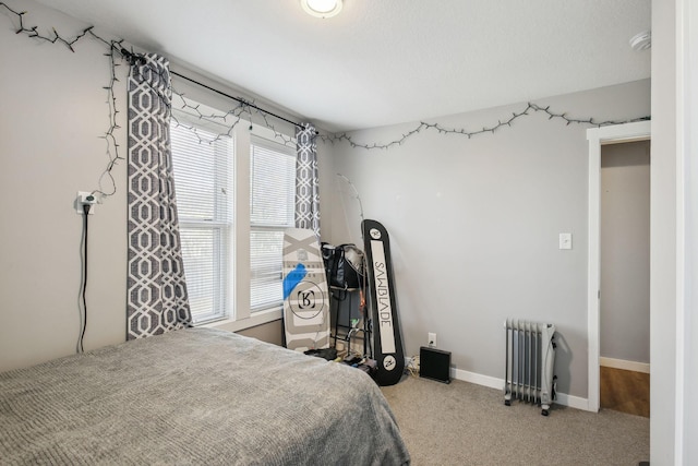 bedroom featuring carpet flooring, radiator heating unit, and a textured ceiling