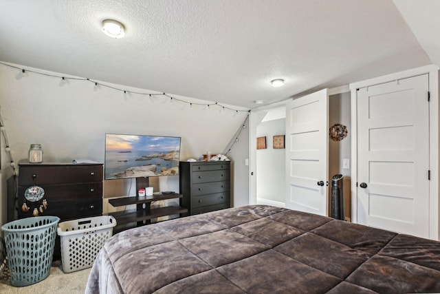 bedroom featuring carpet flooring and a textured ceiling