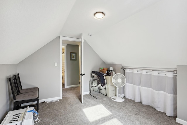 interior space with vaulted ceiling and carpet floors