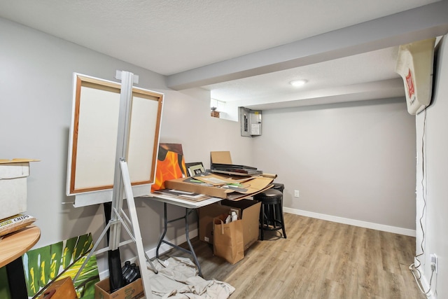 office featuring light hardwood / wood-style flooring and a textured ceiling