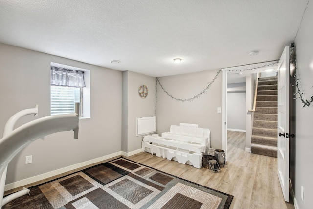 bedroom with wood-type flooring and a textured ceiling