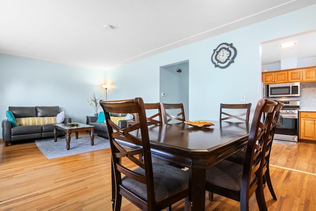 dining area featuring light wood-type flooring