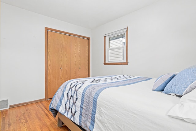 bedroom with a closet and light wood-type flooring