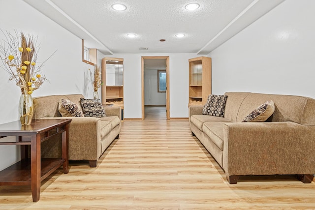 4425 2nd St NE, Columbia Heights, MN 55421 - living area with light wood-style flooring, a textured ceiling, recessed lighting, and baseboards