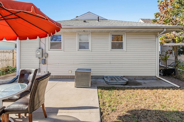 4425 2nd St NE, Columbia Heights, MN 55421 - back of house with fence, a shingled roof, a patio, and central AC