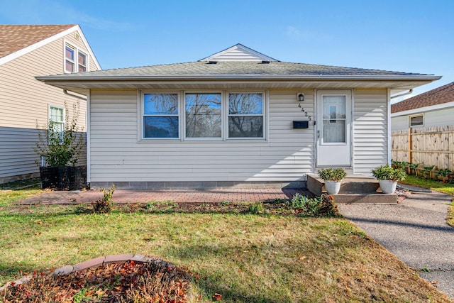 bungalow-style home with a front lawn