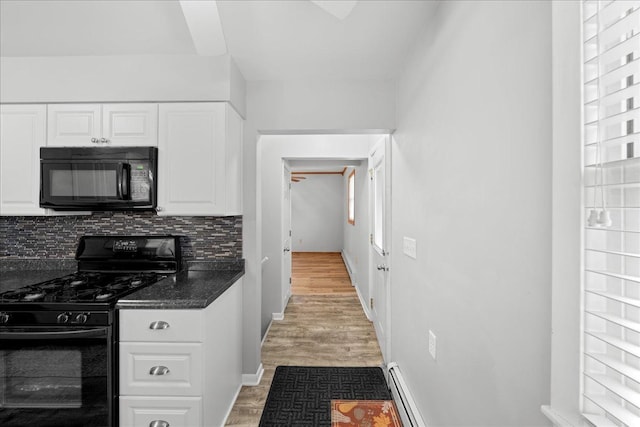 kitchen with backsplash, light hardwood / wood-style floors, white cabinetry, and black appliances