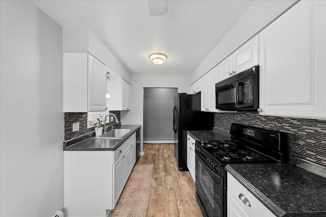 kitchen featuring white cabinetry, sink, backsplash, light hardwood / wood-style floors, and black appliances