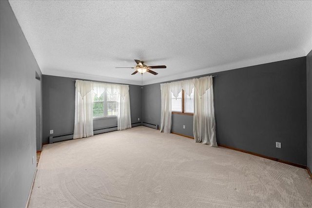 spare room with ceiling fan, light colored carpet, and a textured ceiling