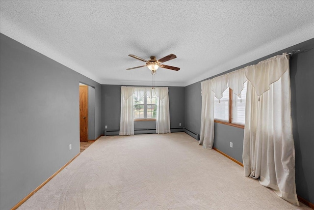 empty room with ceiling fan, carpet, and a textured ceiling