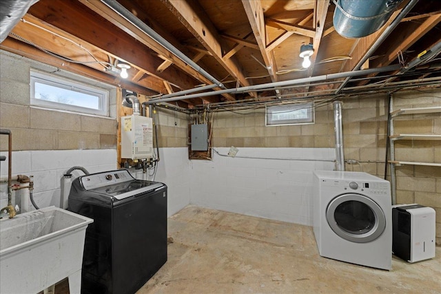 clothes washing area with electric panel, water heater, sink, and independent washer and dryer