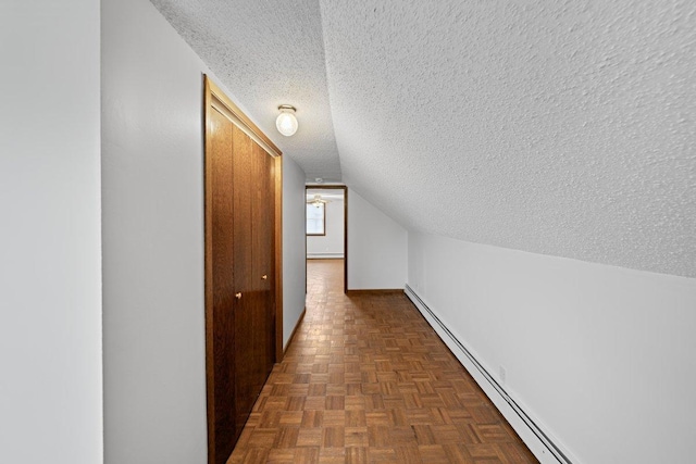 hallway with dark parquet floors, a textured ceiling, vaulted ceiling, and a baseboard heating unit