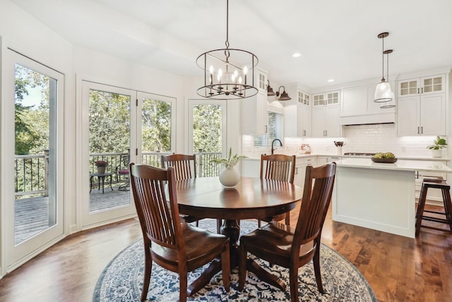 dining room with recessed lighting, a notable chandelier, and wood finished floors