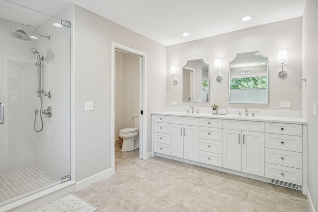 bathroom featuring a stall shower, a sink, and double vanity