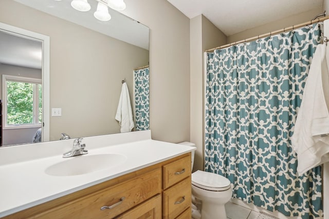 bathroom featuring vanity, toilet, and tile patterned floors